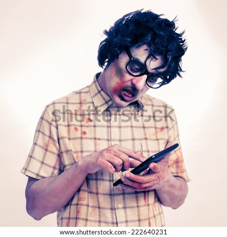 a scary hipster zombie using a tablet computer, with a filter effect