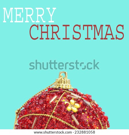 an ornamented red christmas ball and the sentence merry christmas on a blue background with a pop art style