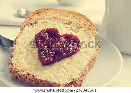 jam forming a heart on a toast, on a set table for breakfast