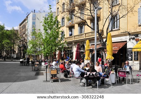 BARCELONA, SPAIN - APRIL 20: People in the restaurant terraces in Passeig del Born on April 20, 2015 in Barcelona, Spain. Born district is a popular area with stores and restaurants in the old town