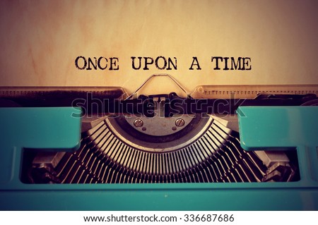 closeup of a blue retro typewriter and the text once upon a time written with it in a yellowish foil Stockfoto © 