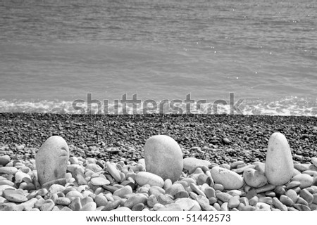 a pile of pebbles in the sea shor in black and white