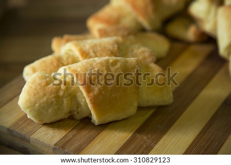 Gluten free rolls on wooden table. Focus is on foreground.