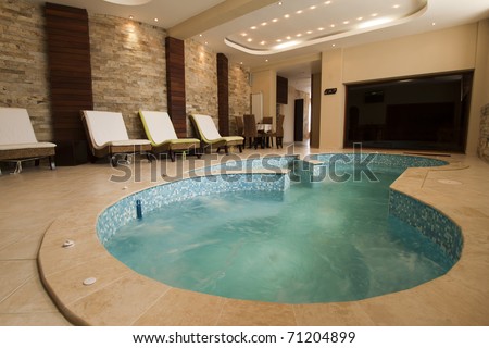 Luxury resort swimming pool with beautiful clean blue water and nice light effects around it.