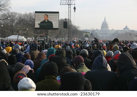 WASHINGTON, DC - JANUARY 20, 2009: Barack Obama is broadcast on the large screens in front of the Capitol Building as record crowds gather for the inauguration on the National Mall, January 20, 2009.