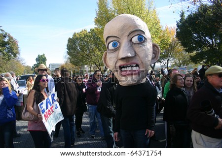 WASHINGTON, DC - OCT 30: A man with a fear-based head puppet walks among the crowd at the Stewart/Colbert Rally to Restore Sanity and/or Fear, Oct. 30, 2010 on the National Mall in Washington, DC.