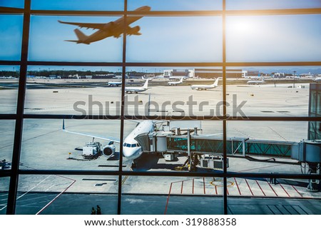 airport windows and airplane at sunset