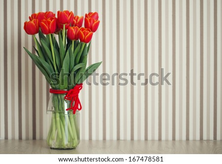 vase of tulips on table