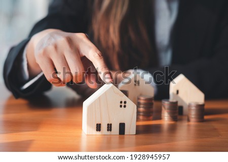 house model ,The hand of the businessman guarding close Money saving ideas to buy a home or loan for real estate investment planning and ideas during saving can be risky. Foto stock © 