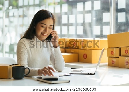 Portrait young attractive asia female owner startup business look at camera work happy with box at home prepare parcel delivery in sme supply chain, procurement, omnichannel commerce online concept. Stockfoto © 