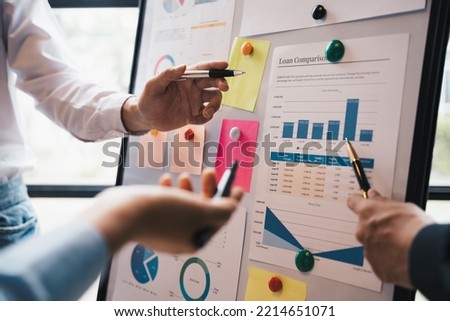 Business colleagues point and explaining to Monthly Budget, Financial and loan comparison on board, team work concept. Foto stock © 