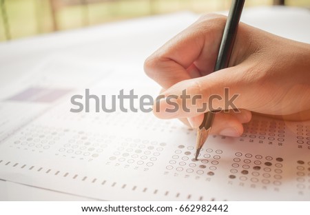 hand student testing in exercise and taking fill in exam carbon paper computer sheet with pencil at school test room, education concept Foto stock © 