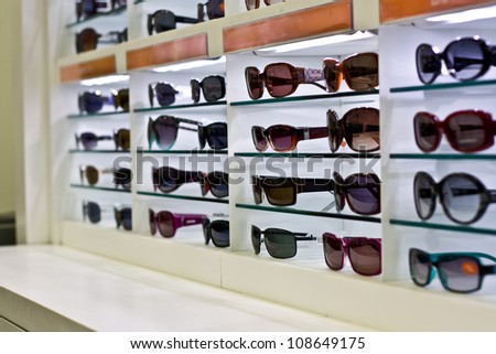 shelves of sunglasses on a shop display.