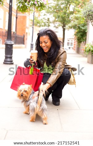 young woman with dog and shopping bags.