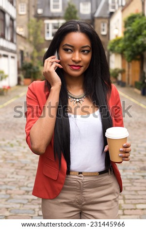 young woman on the phone with a coffee
