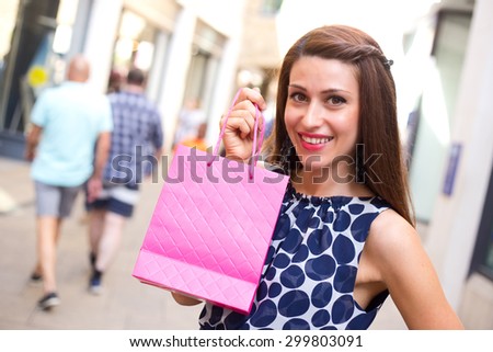 young woman showing a shopping bag