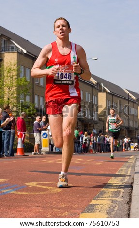 VIRGIN LONDON MARATHON - APRIL 17: an unidentified man running the London virgin marathon on April 2011, the London marathon is a annual event.