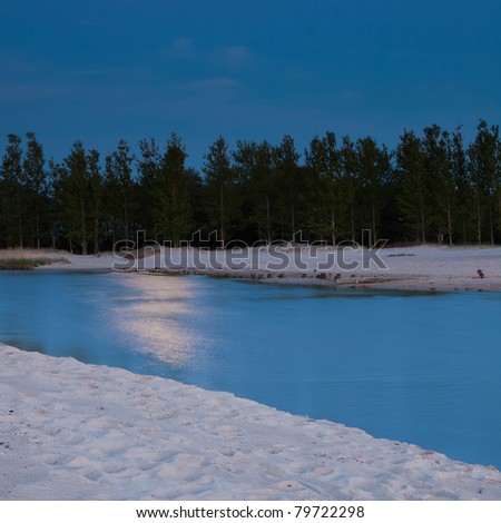 moon light shining on river at blue hour