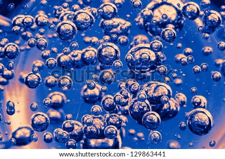 Sparkling bubbles similar to the Universes on a blue background.