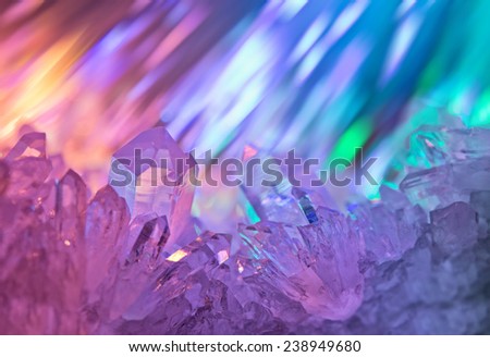 Sparkling multi-colored background with rays of light and crystals of rock crystal.