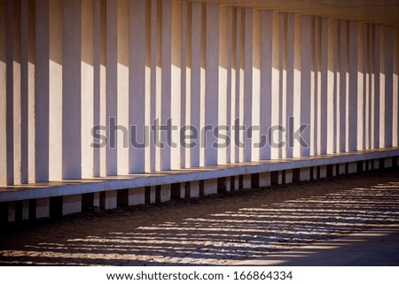 Sunlight and Shadows Through Columns of Building. Horizontal shot