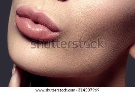 Face part. Beautiful female lips with natural makeup, clean skin