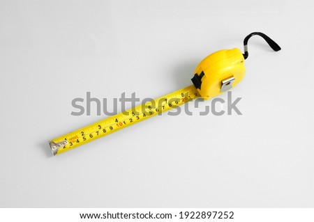 Measuring tape scale yellow roll construction tool inch centimeters size isolated on white background meter equipament work precise Stok fotoğraf © 