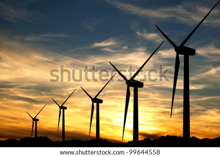 Similar – Image, Stock Photo Silhouettes of some wind mills on the top of a mountain during a super orange sunset with copy space peaceful