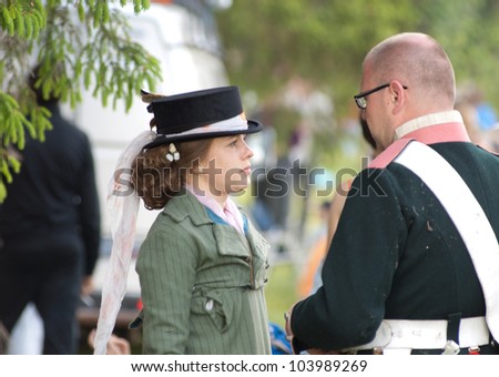 MOSCOW REGION, RUSSIA - MAY 27: Unidentified man and woman talk during 200 unniversary re-enactment of the Borodino battle between Russian and French armies in 1812. May 27, 2012 in Borodino, Russia