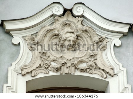Building relief detail of architectural frieze with human head