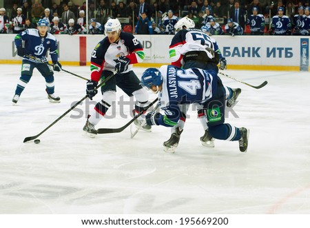 MOSCOW, RUSSIA - JANUARY 28, 2014: Janne Jalasvaara (46) fall down during the KHL hockey match Dynamo Moscow vs Slovan Bratislava in sport palace Luzhniki in Moscow, Russia. Final score 2:3