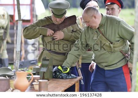 RUSSIA, CHERNOGOLOVKA - MAY 17: Unidentified men reloads in military uniform on History reenactment of battle of Civil War in 1914-1919 on May 17, 2014, Chernogolovka city, Ivanovskoe village, Russia