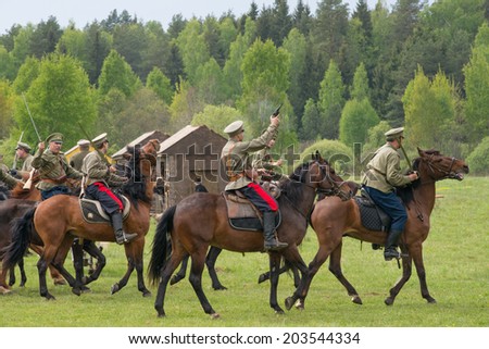 RUSSIA, CHERNOGOLOVKA - MAY 17: Cavalry with swords ride on horses on History reenactment of battle of Civil War in 1914-1919 on May 17, 2014, Russia