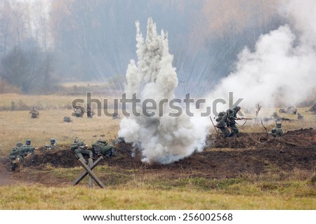 RUSSIA, BORODINO - OCTOBER 12: Unidentified armed german soldiers sit down on the field on reenactment of the battle in WWII near the Borodino village in 1941, in on 12 October, 2014, Russia