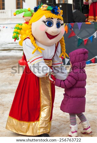 PODOLSK, OSTAFIEVO, RUSSIA - FEBRUARY 21: Unidentified girl dance with a doll on Russian religious and folk holiday Maslenitsa in estate Ostafievo on February 21, 2015, near Podolsk, Russia