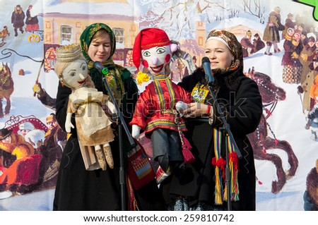 PODOLSK, OSTAFIEVO, RUSSIA - FEBRUARY 21: Unidentified women with folk dolls on a scene on Russian religious and folk holiday Maslenitsa in estate Ostafievo on February 21, 2015, near Podolsk, Russia
