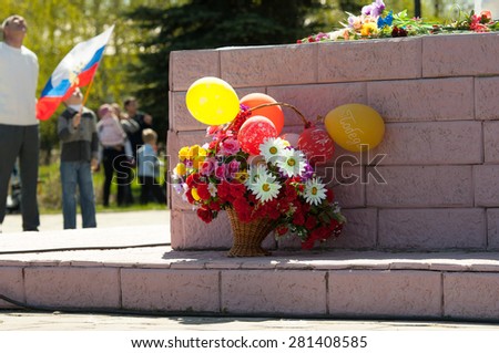 RUSSIA, ROSTOV CITY - MAY 9: Unidentified people stand near the monument with flowers on Victory day parade dedicated 70 anniversary of WWII end on May 9, 2015,  Rostov the Great city, Russia