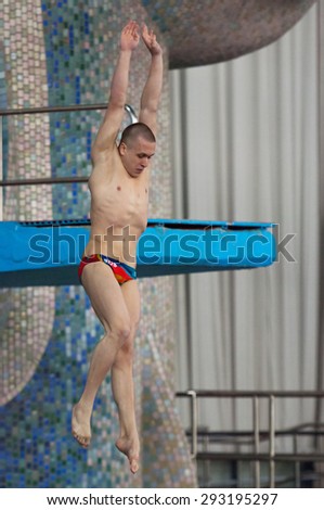 RUSSIA, MOSCOW - APRIL 29 2015: Athlete Sergey Nikolaev jumps from diving-tower in Pool on Moscow city diving tournament in Moscow, Russia, 2015