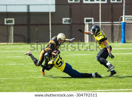 RUSSIA, TROITSK CITY - JULY 11: A. Kozlov (88) and A. Rodionichev (55) fight on Russian american football Championship game Spartans vs Raiders 52 on July 11, 2015, in Moscow region, Troitsk, Russia