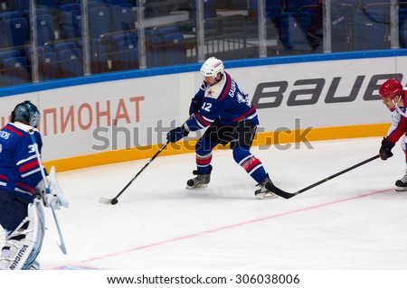 RUSSIA, MOSCOW - APRIL 27, 2015: Egor Bashkatov (12) attack on hockey game CSKA vs SKA teams on Hockey Cup of Legends in Ice Palace VTB, Moscow, Russia