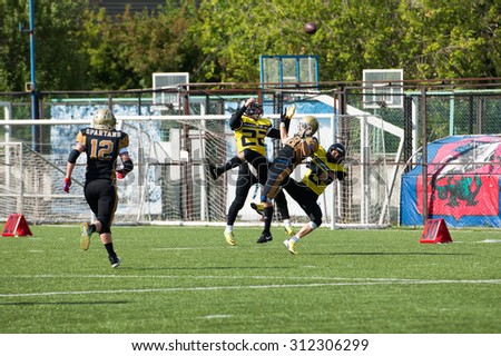 RUSSIA, TROITSK CITY - JULY 11:  A. Starodubtsev (18) fall down getting ball on Russian american football Championship game Spartans vs Raiders 52 on July 11, 2015, in Moscow region, Troitsk, Russia