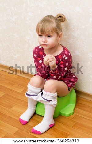 Little Girl Is Sitting On The Green Children'S Potty, Loose Tights ...