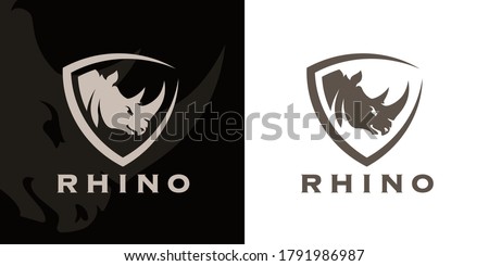 Concept Rhino head and shield company logo icon. Premium Rhinoceros brand identity emblem. African animal business sign. Vector illustration.