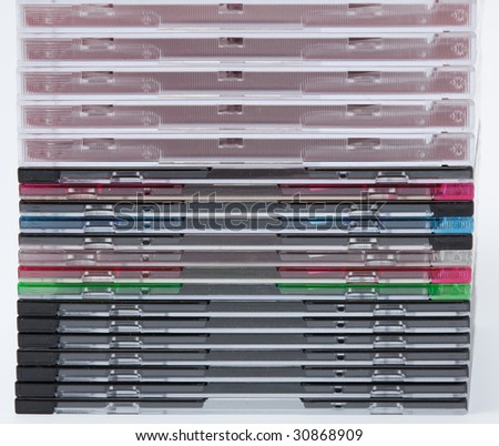 a blank dvd or cd with stack of empty cd cases on background