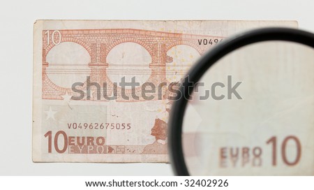 magnifying glass and paper currency