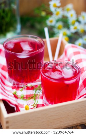 Fruit compote with ice glass jars on a wooden tray