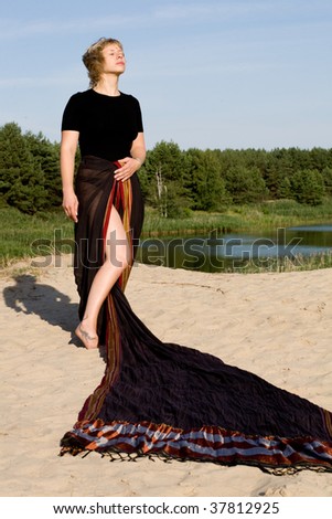 woman dressing Indian saris washes on the beach