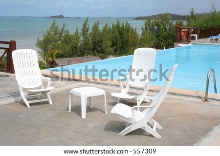 White plastic furniture by the pool