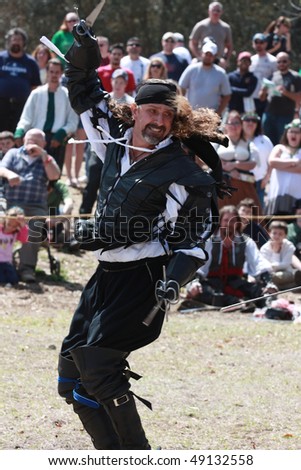 TAMPA FLORIDA- MARCH 13: Gentlemen dressed up in Renaissance clothing sword fight during a show for the audience on March 13, 2010 in Tampa, Florida.