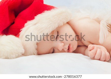 Sleeping cute baby in Santa Claus red hat cloce-up